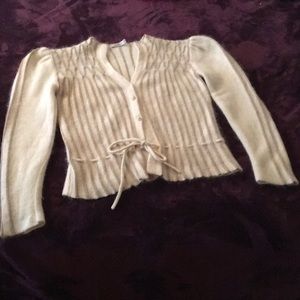 A white and gold striped cashmere sweater